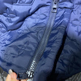 Back view of Louis Vuitton luxury clothing with label-forward styling
