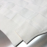 Flat lay presentation of Louis Vuitton luxury clothing with monogram-inspired silhouette
