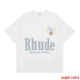 Close-up detail shot of Rhude luxury clothing with signature branding