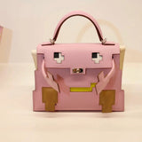  streamlined top-handle bag styled with outfit