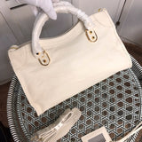 Front view of polished premium women's handbag – women's statement bag