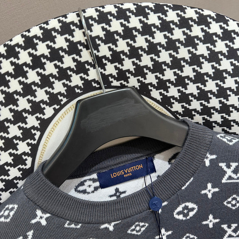 Flat lay presentation of Louis Vuitton luxury clothing with label-forward styling