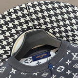 Flat lay presentation of Louis Vuitton luxury clothing with label-forward styling