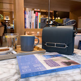 Side view of understated structured handbag