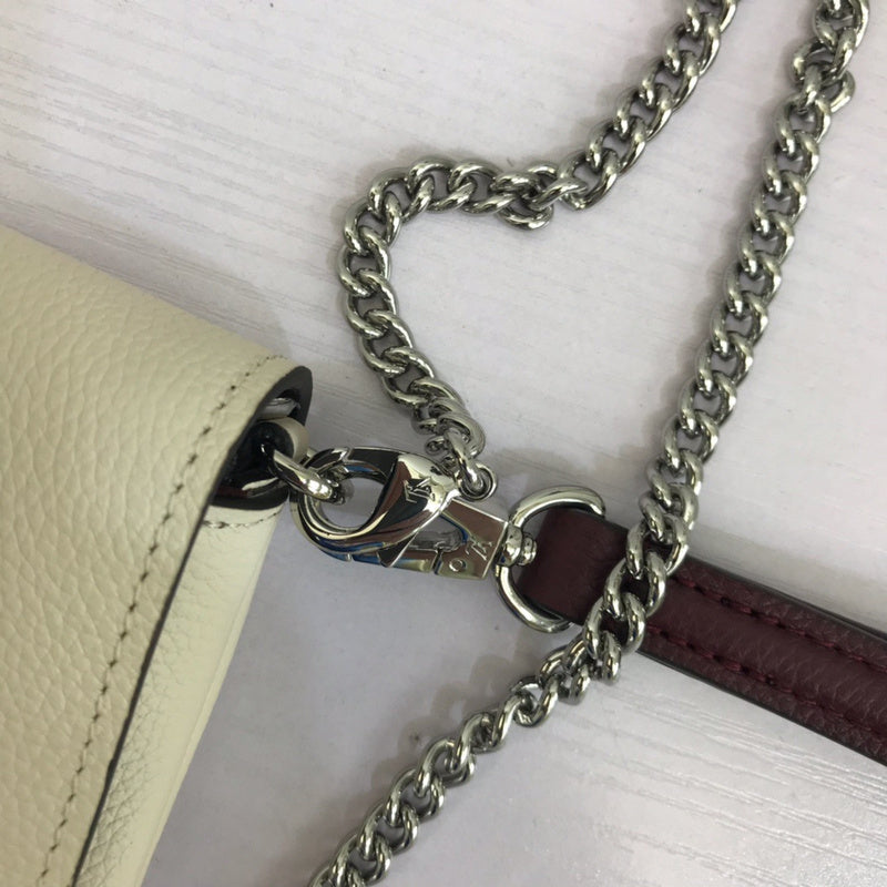 Handle and strap detail of polished premium women's handbag – women's luxury handbag