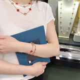Lifestyle view of Van Cleef & Arpels unisex jewelry piece