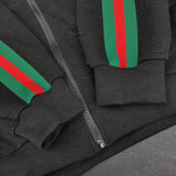 Flat lay presentation of Gucci luxury clothing with label-forward styling