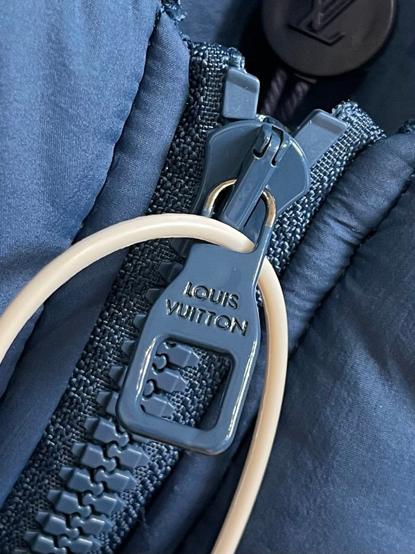 Flat lay presentation of Louis Vuitton luxury clothing with logo-detail design