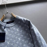 Flat lay presentation of Louis Vuitton luxury clothing with logo-detail design