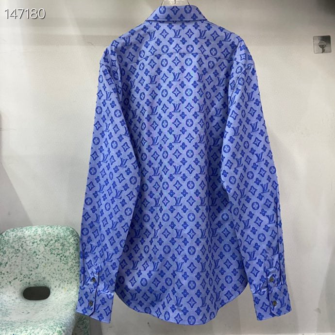 Flat lay presentation of Louis Vuitton luxury clothing with signature branding