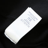 Close-up detail shot of Louis Vuitton luxury clothing with tailored silhouette