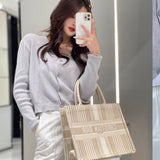 Side profile of modern statement women's handbag – women's luxury accessory