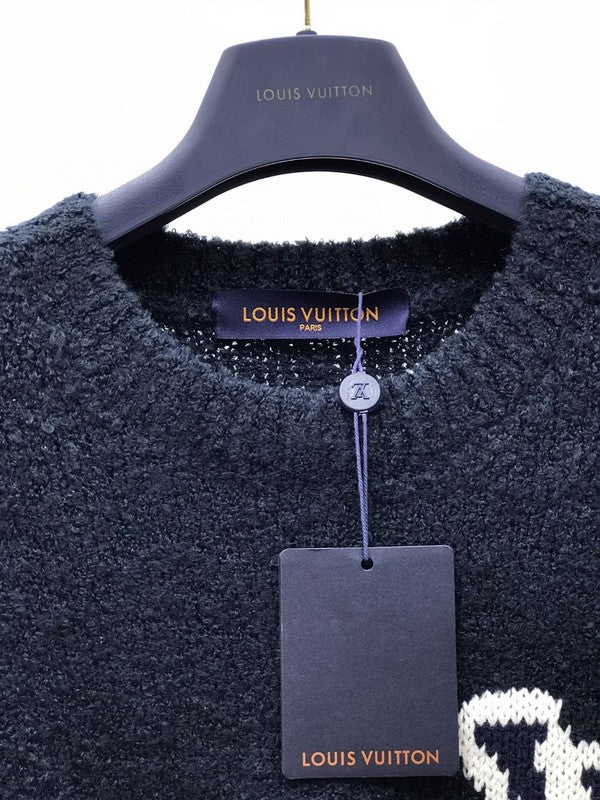 Flat lay presentation of Louis Vuitton luxury clothing with label-forward styling
