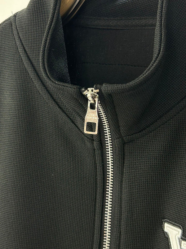 Close-up detail shot of Louis Vuitton luxury clothing with runway-inspired design