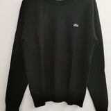 Flat lay presentation of Lacoste luxury clothing with logo-detail design