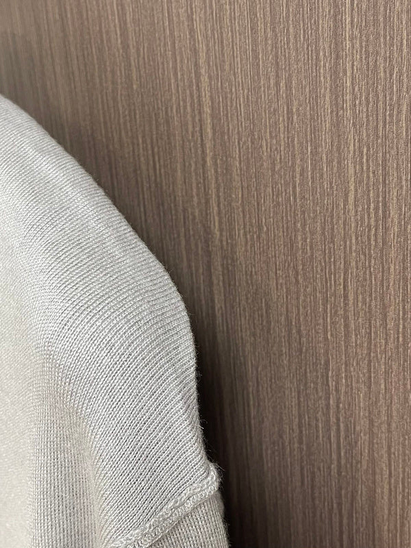 Close-up detail shot of Louis Vuitton luxury clothing with signature branding