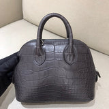 Side view of sleek structured handbag
