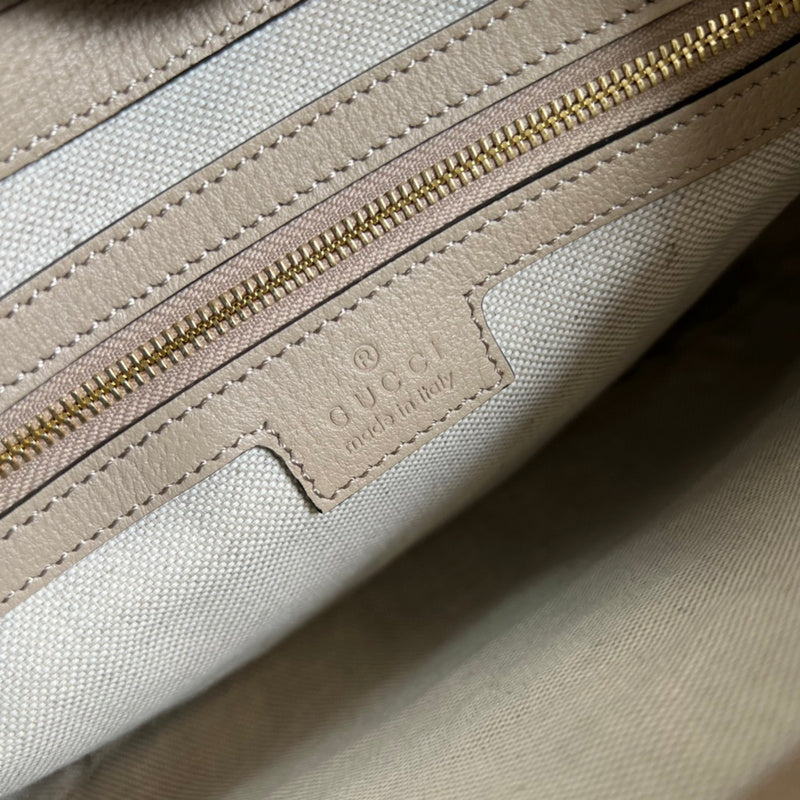 Side profile of polished structured women's handbag – women's statement bag