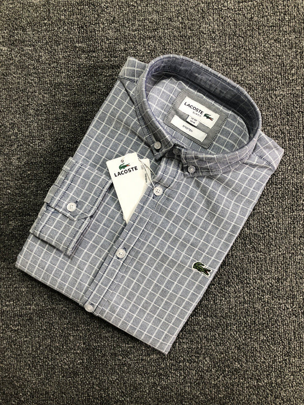 Flat lay presentation of Lacoste luxury clothing with logo-detail design
