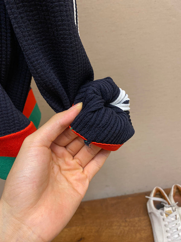 Close-up detail shot of Gucci luxury clothing with label-forward styling