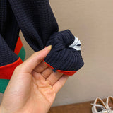 Close-up detail shot of Gucci luxury clothing with label-forward styling