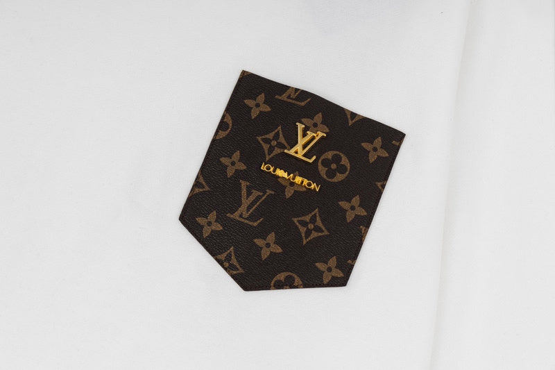 Flat lay presentation of Louis Vuitton luxury clothing with label-forward styling