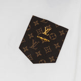 Flat lay presentation of Louis Vuitton luxury clothing with label-forward styling