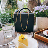 Side view of clean-lined structured handbag