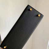 Side view of sculpted structured handbag