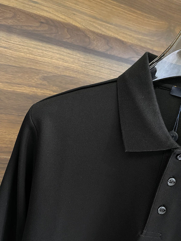 Close-up detail shot of Louis Vuitton luxury clothing with label-forward styling
