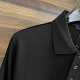 Close-up detail shot of Louis Vuitton luxury clothing with label-forward styling