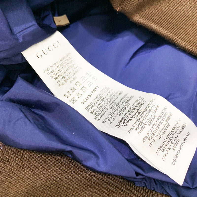 Close-up detail shot of Gucci luxury clothing with label-forward styling