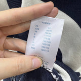 Close-up detail shot of Louis Vuitton luxury clothing with label-forward styling
