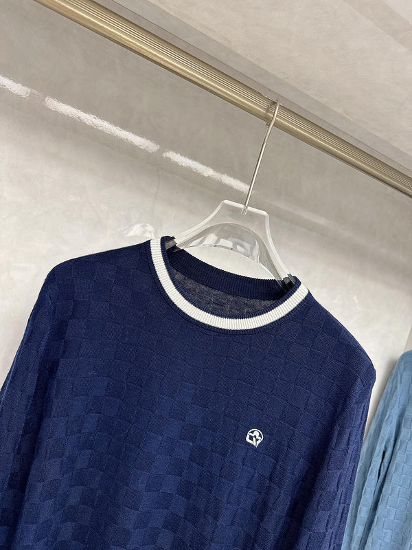 Flat lay presentation of Louis Vuitton luxury clothing with signature branding