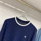 Flat lay presentation of Louis Vuitton luxury clothing with signature branding