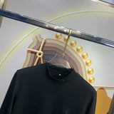 Close-up detail shot of Louis Vuitton luxury clothing with monogram-inspired silhouette