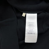 Side profile of Gucci luxury clothing with signature branding