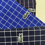 Back view of Lacoste luxury clothing with monogram-inspired silhouette
