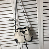 Side profile of statement structured women's handbag – women's luxury accessory