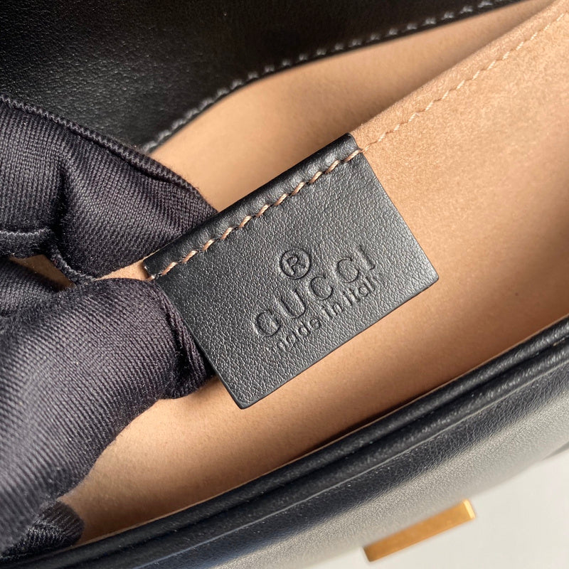 Side profile of classic polished women's handbag – women's statement bag