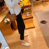 Side view of fluid structured handbag