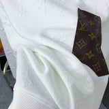 Front view of Louis Vuitton luxury clothing with label-forward styling