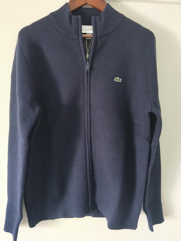Flat lay presentation of Lacoste luxury clothing with monogram-inspired silhouette