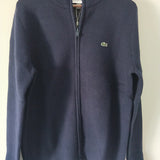 Flat lay presentation of Lacoste luxury clothing with monogram-inspired silhouette