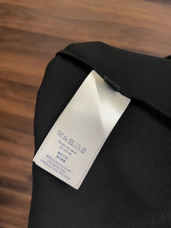 Close-up detail shot of Louis Vuitton luxury clothing with label-forward styling