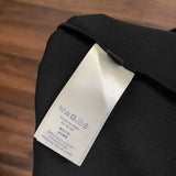 Close-up detail shot of Louis Vuitton luxury clothing with label-forward styling