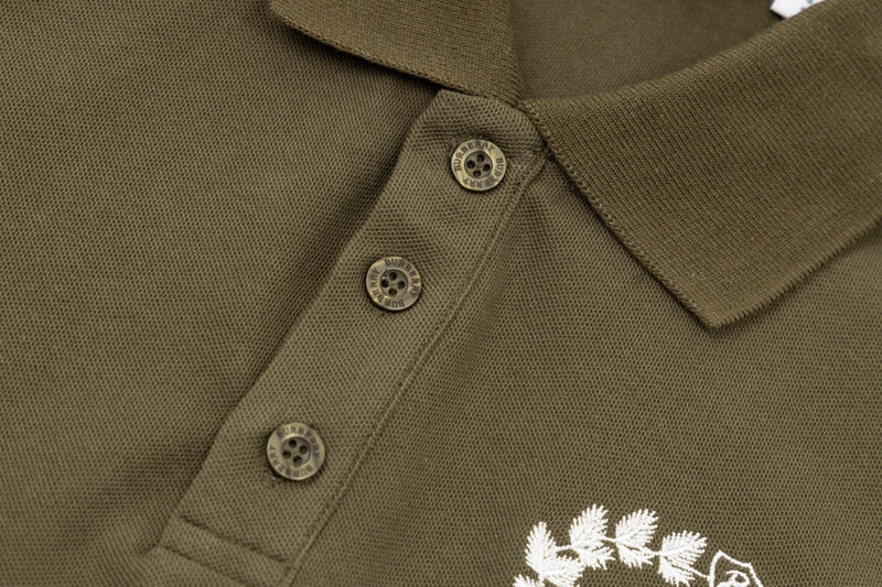 Close-up detail shot of Polo cotton polo shirt with monogram-inspired silhouette