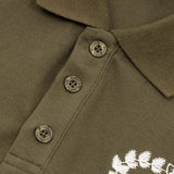 Close-up detail shot of Polo cotton polo shirt with monogram-inspired silhouette