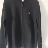Front view of Lacoste luxury clothing with monogram-inspired silhouette