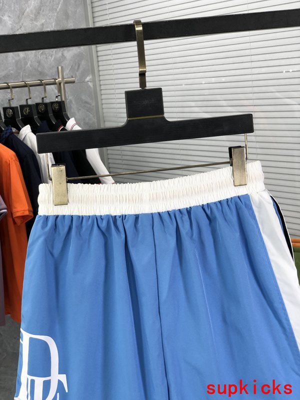 Flat lay presentation of Rhude luxury clothing with runway-inspired design